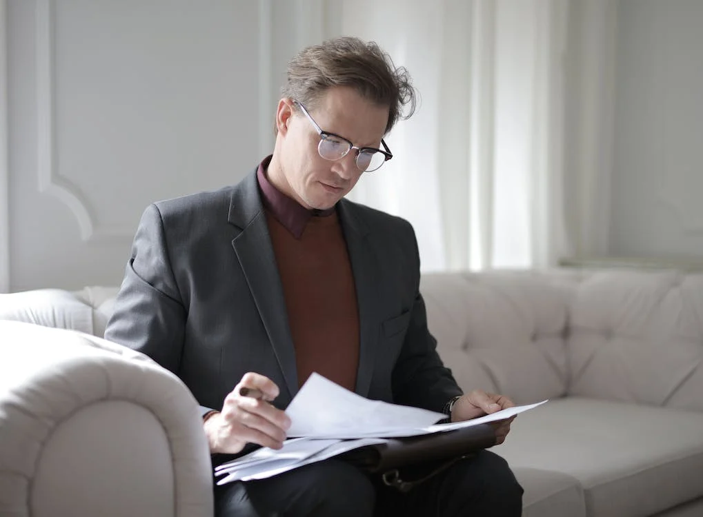 A photo showing a man reviewing documents