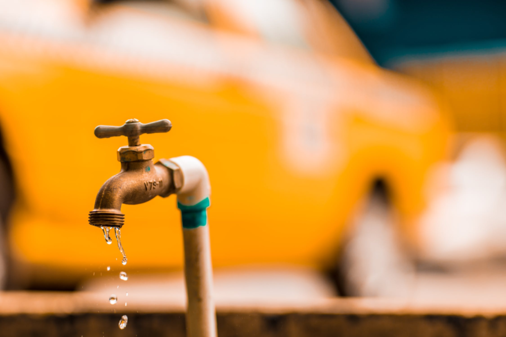 A photo showing water leaking from a faucet outdoors.