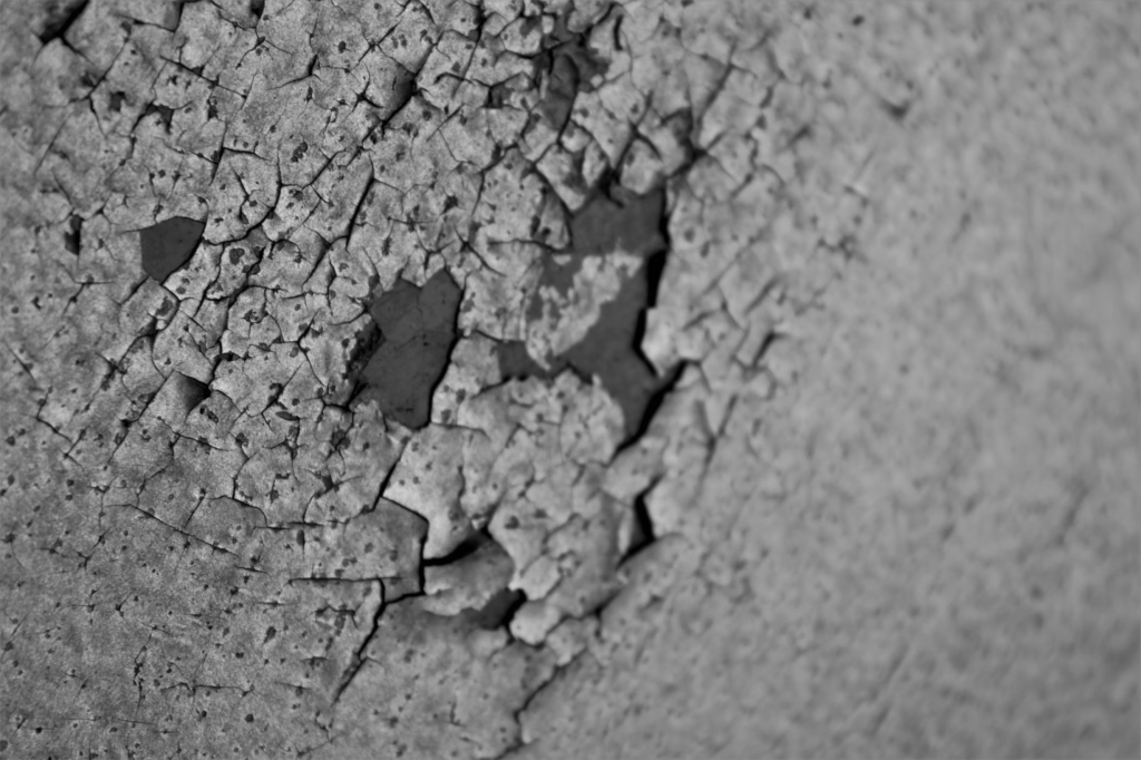 A photo showing a cement surface with cracks.