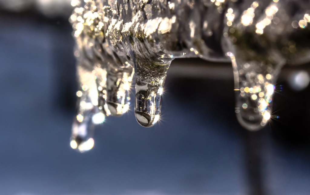 A photo showing water droplets dripping off an object.