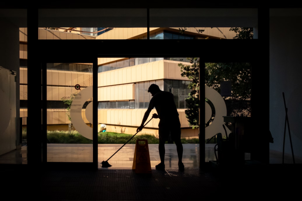 A photo showing a person mopping a floor inside a building