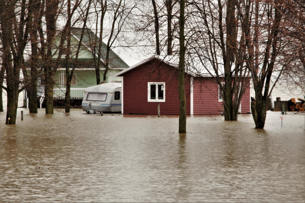 A photo showing a flooded property with an RV