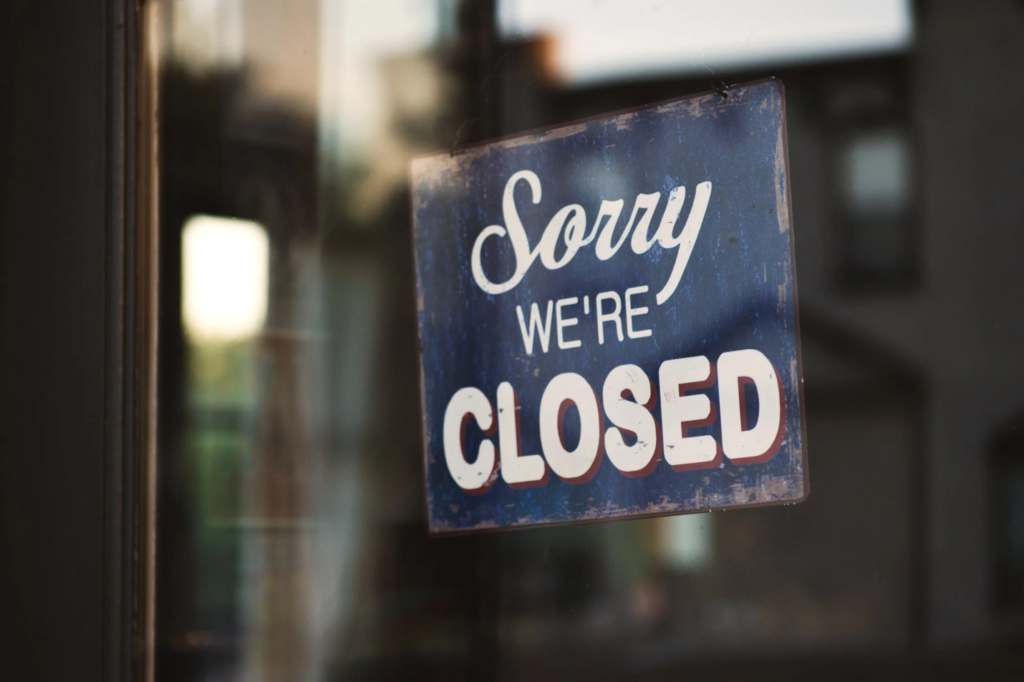 A “closed” sign on a business’s window following commercial water damage.