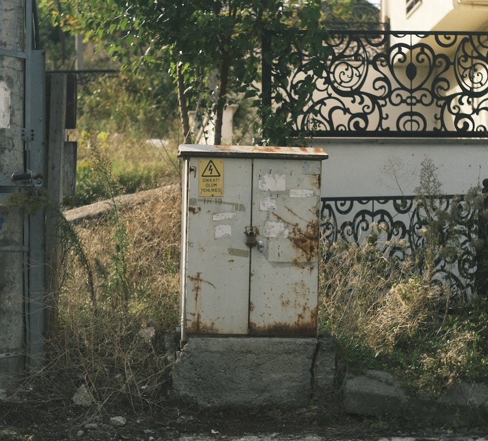 A photo showing a rusted electrical panel outdoors.