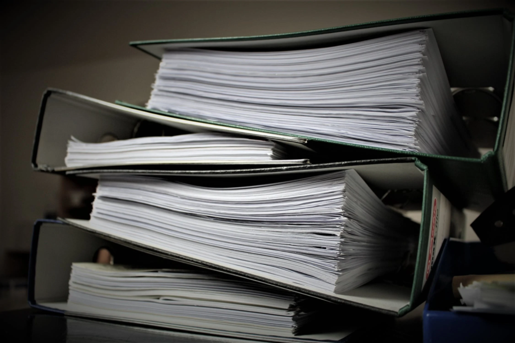 A photo showing a stack of green folders.