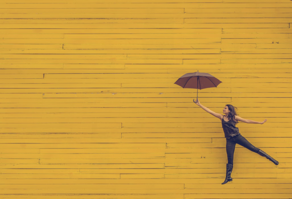 A photo showing a woman holding an umbrella.