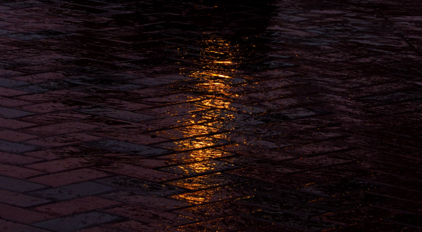 Water standing on a pavement.
