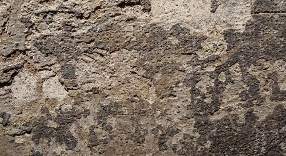 A cement wall with water damage.