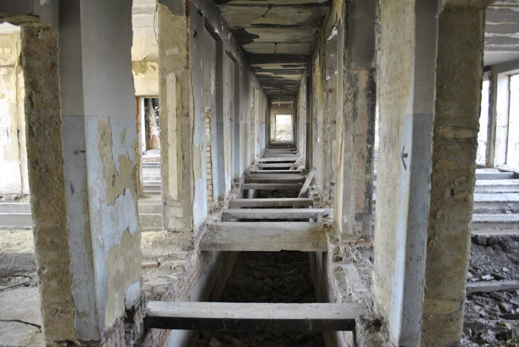 An office space affected by contaminated water damage by https://unsplash.com/photos/a-row-of-benches-in-a-run-down-building-C1ilxVFskSc